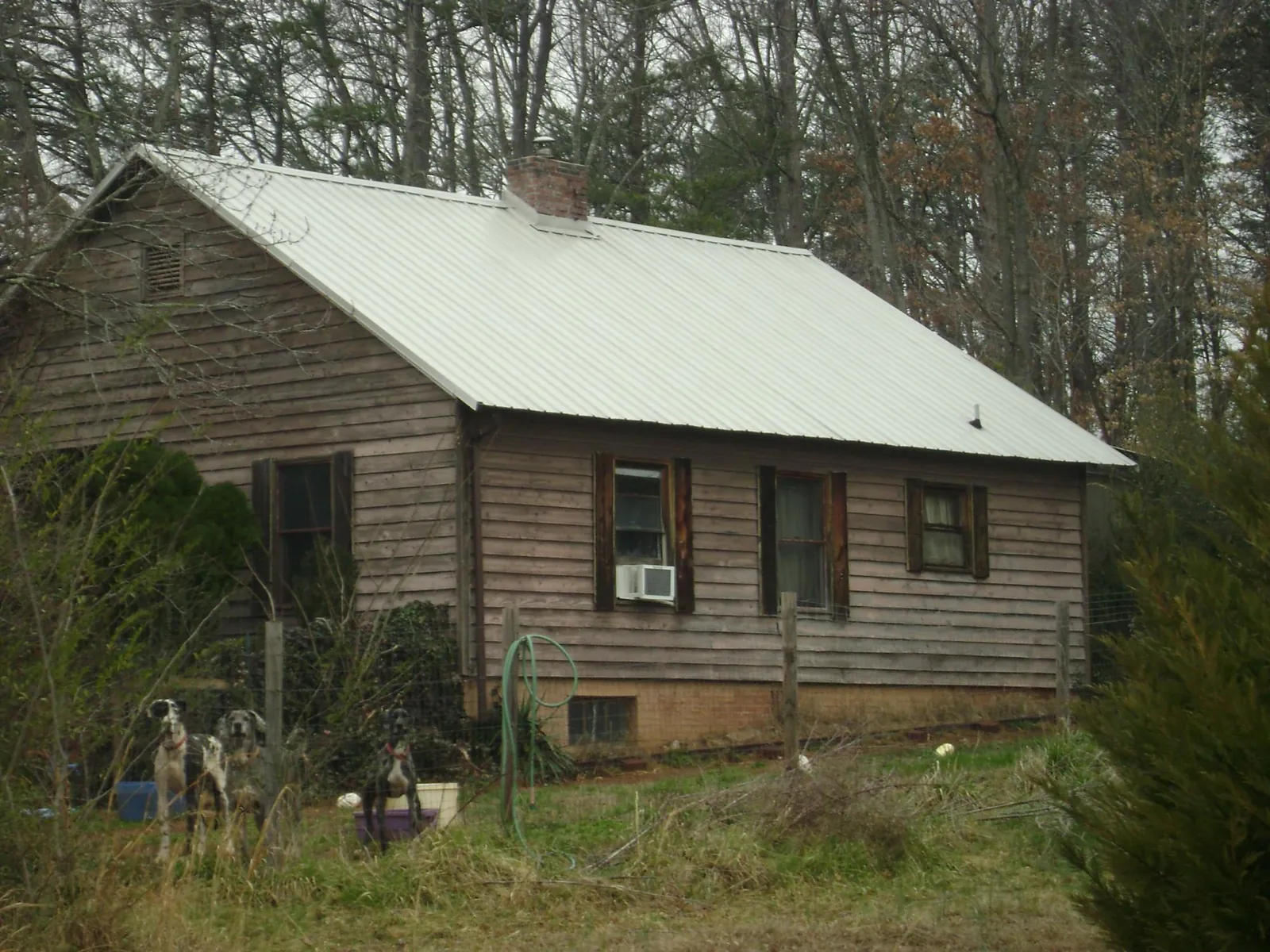 White metal roof on an old wood sided farmhouse, from a Asphalt Shingle Roof Repair job in Massapequa Park